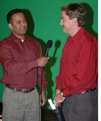 Bill Tipton responding to a question; with red shirt and gray slacks